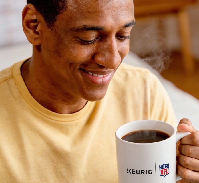 Person holding Keurig x NFL mug