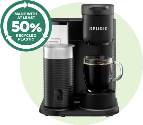 K-Cafe Essentials® coffee maker in black with a green burst, indicating it's made from at least 50% recycled plastic.