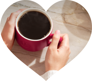 Hands holding a warm mug of coffee